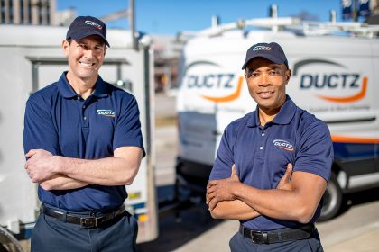 DUCTZ air duct cleaning franchise technicians in front of vans
