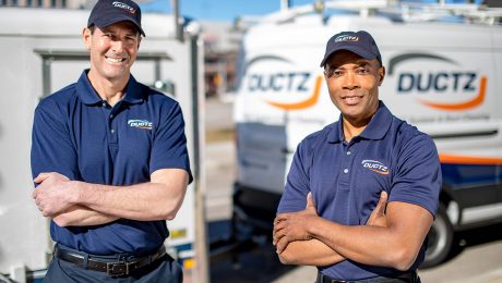 DUCTZ air duct cleaning franchise technicians in front of vans